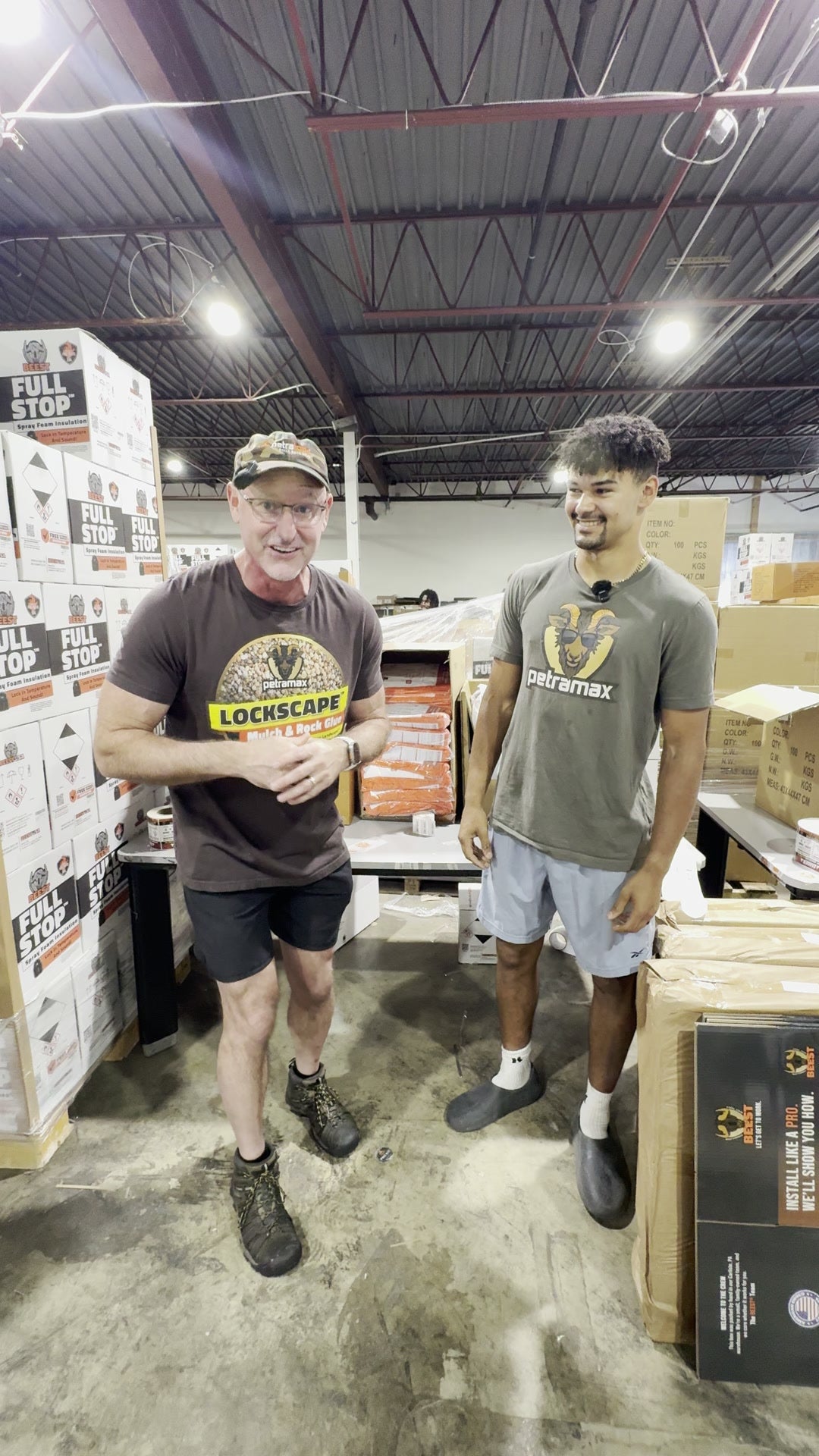 Andy and AJ in the warehouse beside BEEST FullStop spray foam inventory